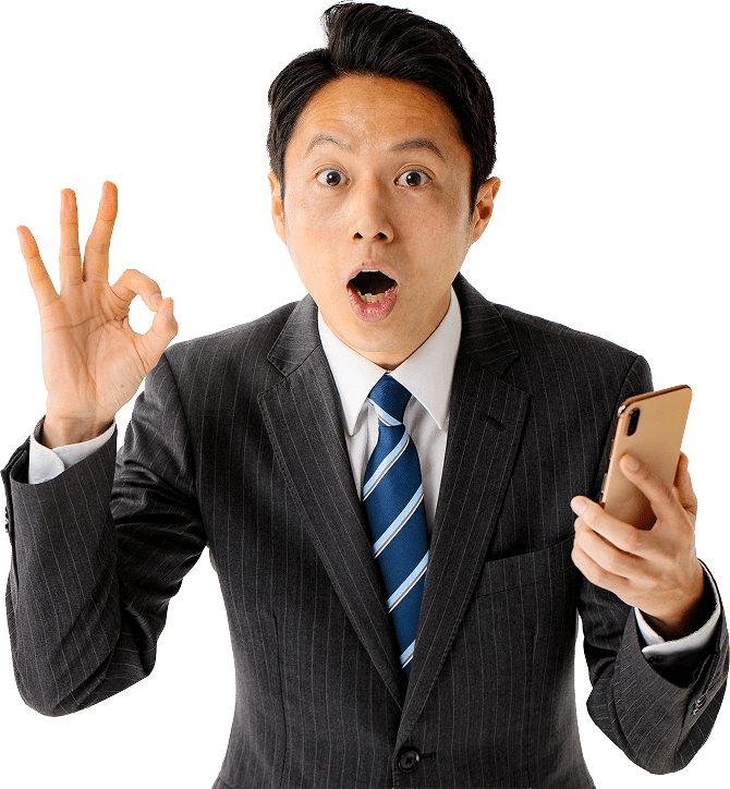 スマートフォンを持って指を立てている男性の写真